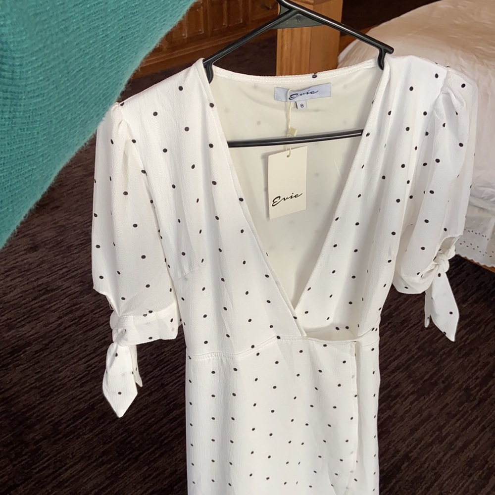 New with tags wrap dress with ties on sleeves . Super cute, fun, flowy dress.